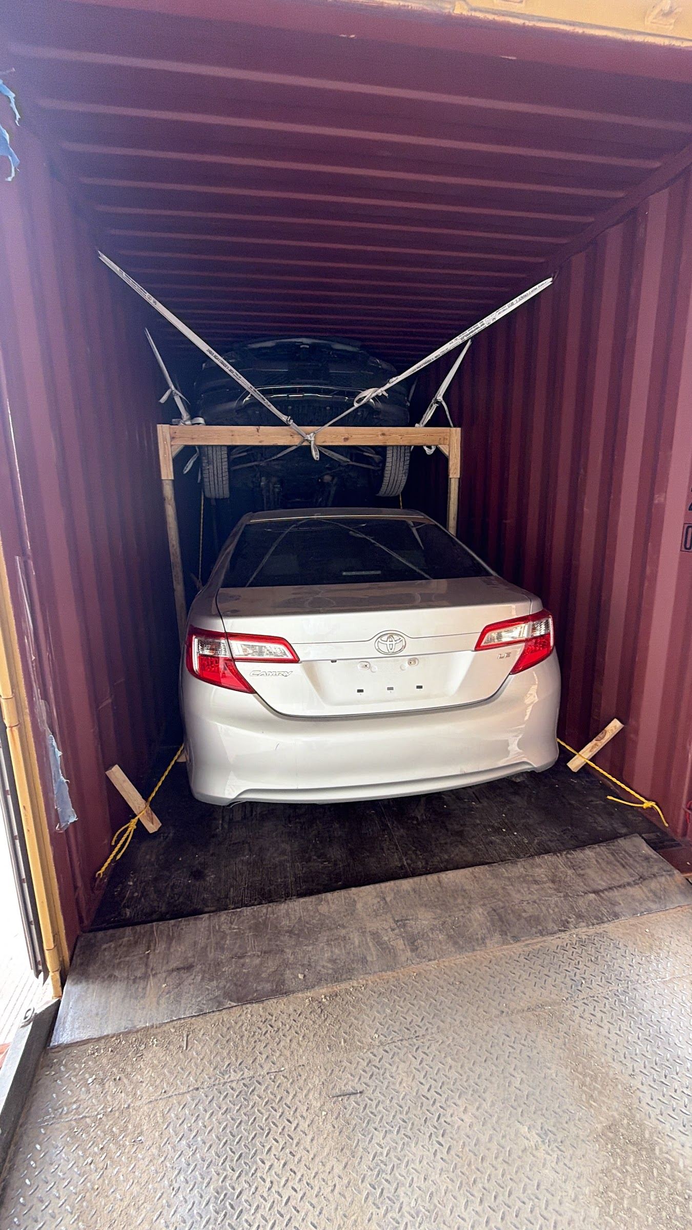 Two vehicles braced and secured inside a shipping container at Ajeeb Overseas